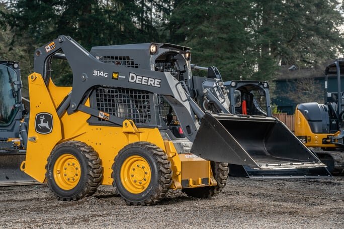 Photograph is showing skid steer loader on site