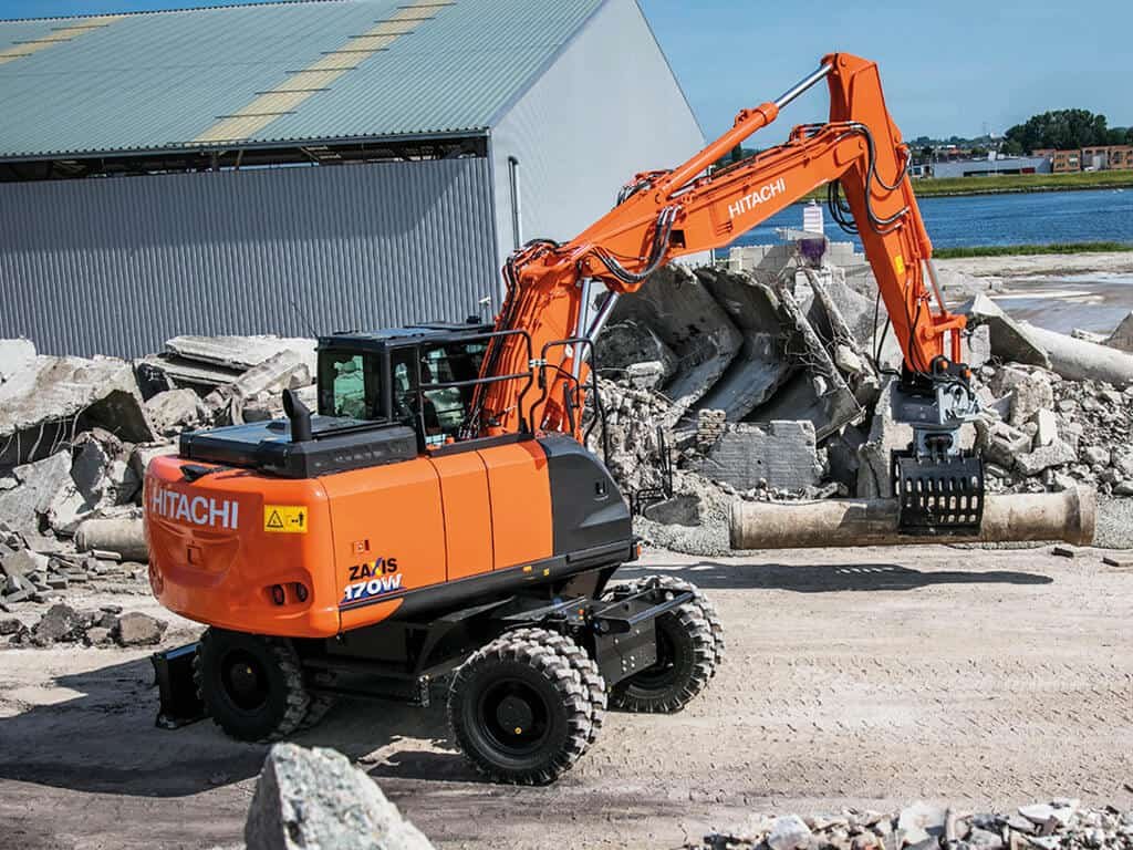 Onsite photograph of wheeled excavators during demolition