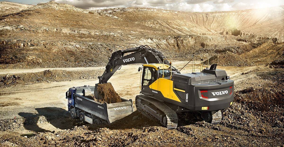 Photograph is showing the crawler excavator working productively with its tracks