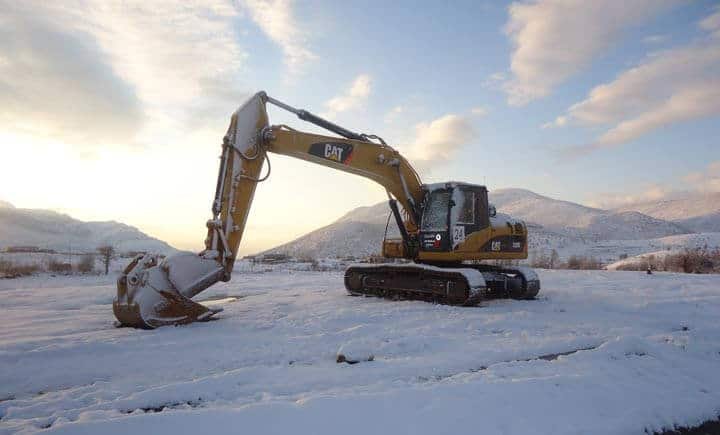 Onsite photograph of crawler excavators during snow removal